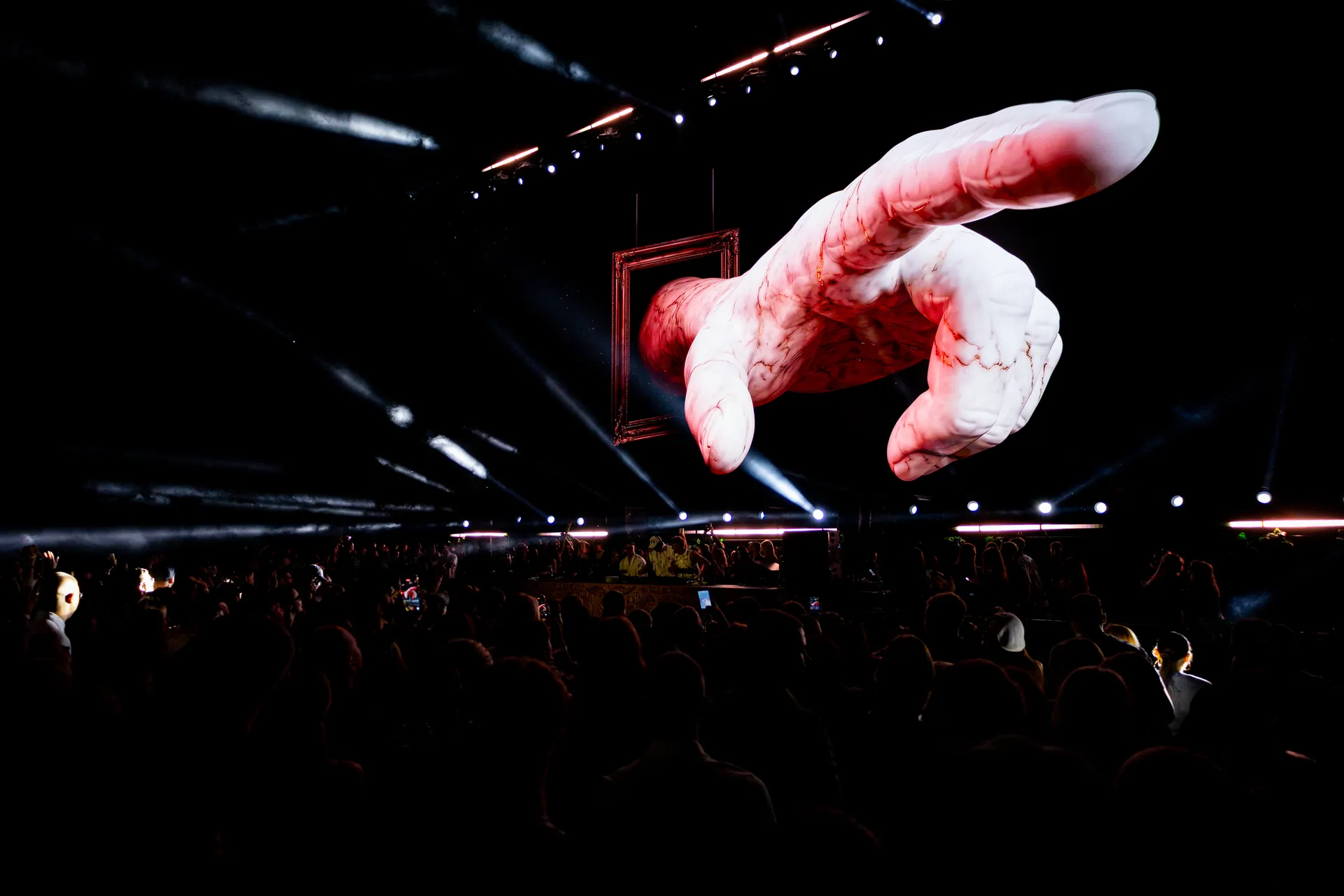 Awakening of Eras — hand reaching through a frame on the LED wall